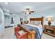 Spacious main bedroom featuring a ceiling fan, a king size bed, and decorative lamps at 10825 W Caron Dr, Sun City, AZ 85351