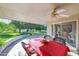 Inviting covered patio with a dining set, ceiling fan, and views of the landscaped backyard at 10825 W Caron Dr, Sun City, AZ 85351