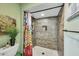 Bathroom featuring a shower, decorative tile, and storage niches at 10825 W Caron Dr, Sun City, AZ 85351