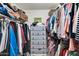 Walk-in closet with built-in shelves, hanging rods, and a dresser at 10825 W Caron Dr, Sun City, AZ 85351