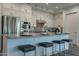 Modern kitchen featuring white cabinets, stainless appliances, and an island with seating at 11673 N 136Th St # 1013, Scottsdale, AZ 85259