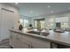 Modern kitchen featuring an island sink with seating, with views of the backyard at 11673 N 136Th St # 1013, Scottsdale, AZ 85259