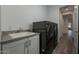Laundry room with sleek, modern washer and dryer set, adjacent to a white utility sink at 11673 N 136Th St # 1013, Scottsdale, AZ 85259