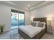 Sunlit main bedroom with a cozy bed, modern decor, and a sliding glass door to the outside at 11673 N 136Th St # 1013, Scottsdale, AZ 85259