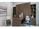 A modern office with a beautiful wooden desk and a Murphy bed surrounded by built-in bookshelves at 11673 N 136Th St # 1013, Scottsdale, AZ 85259