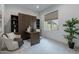 A well-lit office space with a modern murphy bed, a window and a comfortable accent chair at 11673 N 136Th St # 1013, Scottsdale, AZ 85259