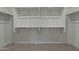 A sizable, well-lit walk-in closet with ample shelving and a carpeted floor at 11673 N 136Th St # 1013, Scottsdale, AZ 85259