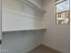 Well-organized walk-in closet with shelving and a window for natural light at 11673 N 136Th St # 1013, Scottsdale, AZ 85259