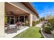 Outdoor seating area, turf yard, and private hot tub at 13211 W Hummingbird Ter, Peoria, AZ 85383