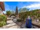 Private backyard oasis with mature landscaping, fire pit, and water feature at 13211 W Hummingbird Ter, Peoria, AZ 85383