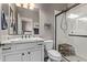 Bathroom features a white single sink vanity, shower with glass doors, and neutral walls at 13211 W Hummingbird Ter, Peoria, AZ 85383
