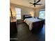 This bedroom features hardwood floors, neutral walls, and a ceiling fan at 13211 W Hummingbird Ter, Peoria, AZ 85383