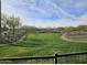 Well-maintained community park with seating and walking paths offers a picturesque view of the neighborhood at 13211 W Hummingbird Ter, Peoria, AZ 85383