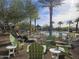 Relaxing community pool area with palm trees and comfortable seating, perfect for leisure at 13211 W Hummingbird Ter, Peoria, AZ 85383