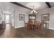 Dining room with beamed ceilings, chandelier, and wood table with chairs at 13211 W Hummingbird Ter, Peoria, AZ 85383
