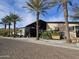 Modern community clubhouse with palm trees and brick-paved parking at 13211 W Hummingbird Ter, Peoria, AZ 85383