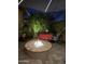 Outdoor fire pit with patio furniture and lush landscaping creates an inviting backyard space at 13211 W Hummingbird Ter, Peoria, AZ 85383