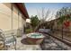 Cozy outdoor fire pit with seating, perfect for enjoying evenings in the private backyard at 13211 W Hummingbird Ter, Peoria, AZ 85383