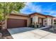 Charming single-story home with a desert landscape, large driveway, and attached garage at 13211 W Hummingbird Ter, Peoria, AZ 85383