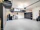 Spacious garage with storage cabinets, overhead racks and epoxy flooring at 13211 W Hummingbird Ter, Peoria, AZ 85383