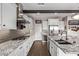 Bright, modern kitchen with stainless steel appliances, granite counters and tile backsplash at 13211 W Hummingbird Ter, Peoria, AZ 85383