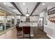 Spacious kitchen featuring beamed ceilings, an island, stainless steel appliances, and tile floors at 13211 W Hummingbird Ter, Peoria, AZ 85383