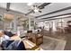 Spacious living room featuring dark wood beams, flooring and neutral decor, which opens to the kitchen and dining area at 13211 W Hummingbird Ter, Peoria, AZ 85383