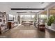 Spacious living room with beamed ceilings, tile floors, and lots of natural light at 13211 W Hummingbird Ter, Peoria, AZ 85383