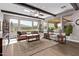 Open living room with beamed ceilings, large windows, and tile floors at 13211 W Hummingbird Ter, Peoria, AZ 85383