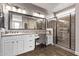 Beautiful main bathroom featuring dual sinks, a vanity, and a glass-enclosed shower at 13211 W Hummingbird Ter, Peoria, AZ 85383