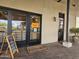 The Market Place entrance with sidewalk menu and Trilogy-branded welcome mat at 13211 W Hummingbird Ter, Peoria, AZ 85383