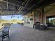 Outdoor patio with comfortable seating, fireplace, and manicured landscaping at 13211 W Hummingbird Ter, Peoria, AZ 85383