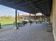 Covered outdoor patio with dining and seating areas, perfect for enjoying the outdoors at 13211 W Hummingbird Ter, Peoria, AZ 85383