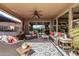 Relaxing covered patio area with plush seating, hot tub, and serene outdoor views at 13211 W Hummingbird Ter, Peoria, AZ 85383
