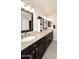 Bright bathroom with a double sink vanity, granite countertop and dark brown cabinets at 13642 S 42Nd St, Phoenix, AZ 85044