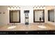 Bathroom featuring double sinks, granite countertops, and decorative mirrors with vanity lighting at 13642 S 42Nd St, Phoenix, AZ 85044