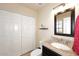 Bathroom featuring granite countertops, vanity with sink, a large mirror, and closet with folding doors at 13642 S 42Nd St, Phoenix, AZ 85044