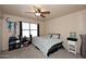 Cozy bedroom featuring a ceiling fan, window with blinds, and comfortable bed with patterned bedding at 13642 S 42Nd St, Phoenix, AZ 85044