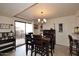 Inviting dining area with a rustic wood table and chairs, enhanced by natural light and stylish wine rack at 13642 S 42Nd St, Phoenix, AZ 85044