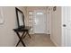 Bright entryway featuring tile flooring, a decorative mirror on an entry table, and white trim at 13642 S 42Nd St, Phoenix, AZ 85044