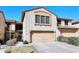 Charming townhome featuring a two-car garage, neutral stucco exterior, and a well-manicured front yard at 13642 S 42Nd St, Phoenix, AZ 85044