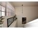 Hallway features a window with blinds, a stylish light fixture, and a framed picture at 13642 S 42Nd St, Phoenix, AZ 85044