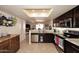 Bright, open kitchen design with dark wood cabinetry, stainless steel appliances, and a clear view into the dining area at 13642 S 42Nd St, Phoenix, AZ 85044