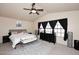 Spacious main bedroom featuring vaulted ceiling, large windows, and a comfortable bed with stylish furniture at 13642 S 42Nd St, Phoenix, AZ 85044