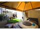 Cozy patio area with a round fire pit, seating, and artificial grass at 13642 S 42Nd St, Phoenix, AZ 85044