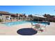 Community pool with multiple lounge chairs and tables for enjoying the sunshine with Gathering and friends at 13642 S 42Nd St, Phoenix, AZ 85044