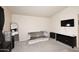 Sitting area includes a grey settee, mounted TV, black cabinet, carpet and black-out curtains at 13642 S 42Nd St, Phoenix, AZ 85044