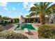 Serene backyard featuring a refreshing pool, lush landscaping, and a palm tree at 1407 E Laguna Dr, Tempe, AZ 85282