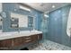 Modern bathroom featuring a double vanity, sleek fixtures, glass shower and vibrant tile work at 1407 E Laguna Dr, Tempe, AZ 85282