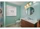 Stylish full bathroom with modern vanity, round mirror, and bright lighting fixtures at 1407 E Laguna Dr, Tempe, AZ 85282